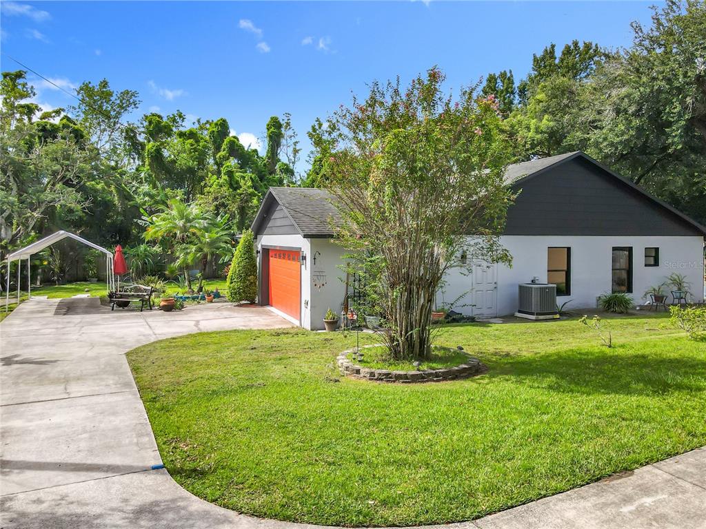 1312 Perkins Road Orlando, FL 32809 - Photo 5 of 80 a view of a house with a backyard porch and sitting area
