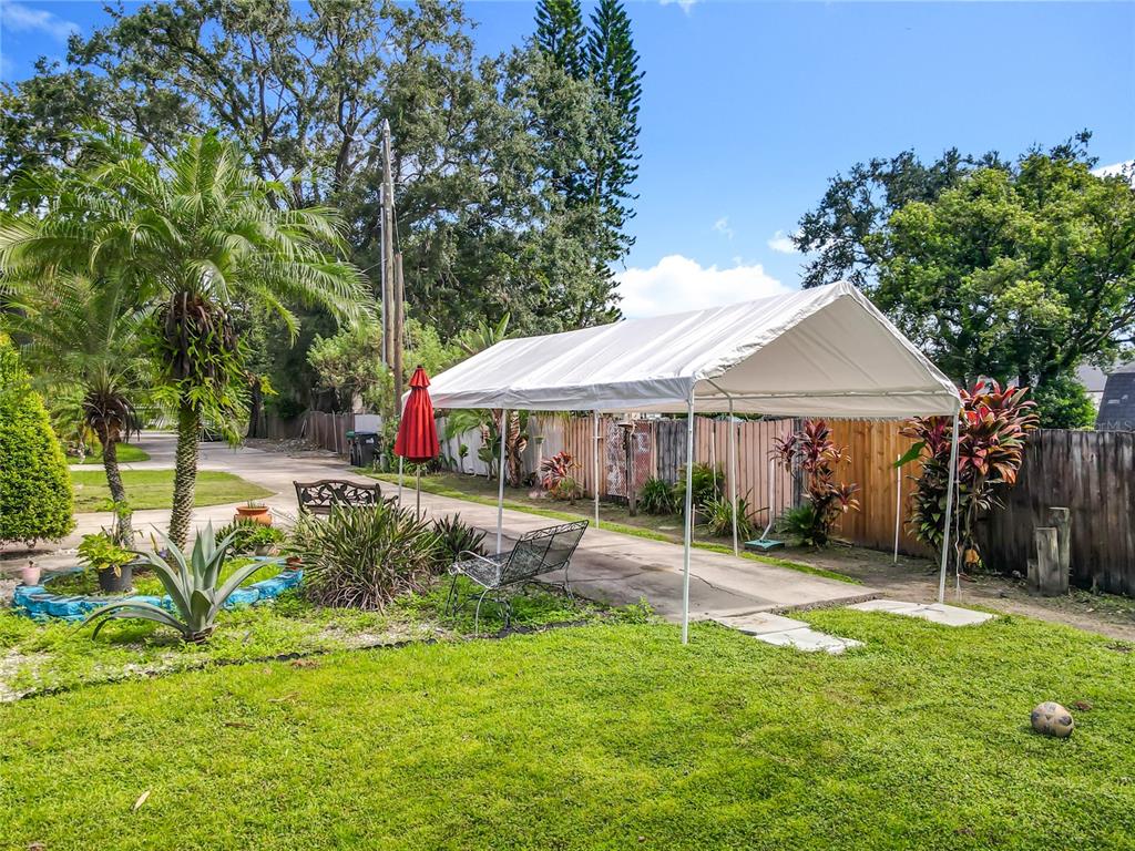 1312 Perkins Road Orlando, FL 32809 - Photo 69 of 80 a backyard of a house with table and chairs