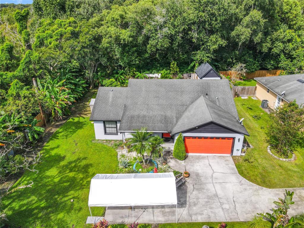 1312 Perkins Road Orlando, FL 32809 - Photo 71 of 80 an aerial view of a house with a yard and garden