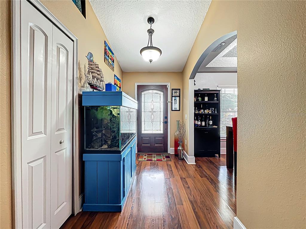 1312 Perkins Road Orlando, FL 32809 - Photo 9 of 80 a view of a hallway with wooden floor and staircase