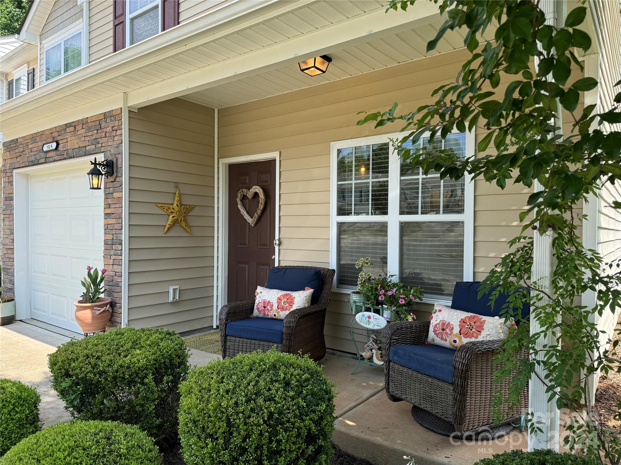 162 Limerick Road, Unit A Mooresville, NC 28115 - Photo 2 of 20 front view of a house with a chairs in a patio