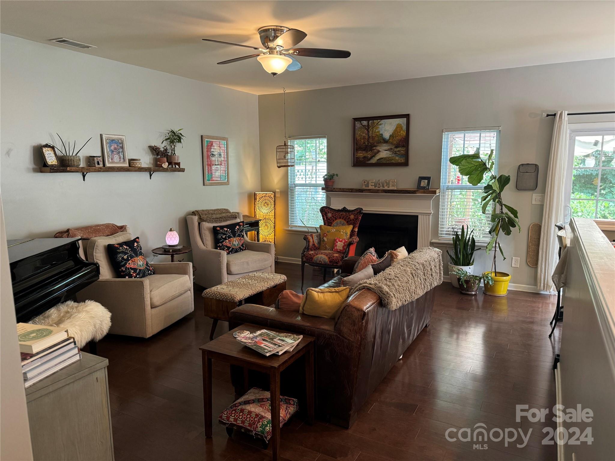 162 Limerick Road, Unit A Mooresville, NC 28115 - Photo 4 of 20 a living room with furniture floor to ceiling window and a fireplace