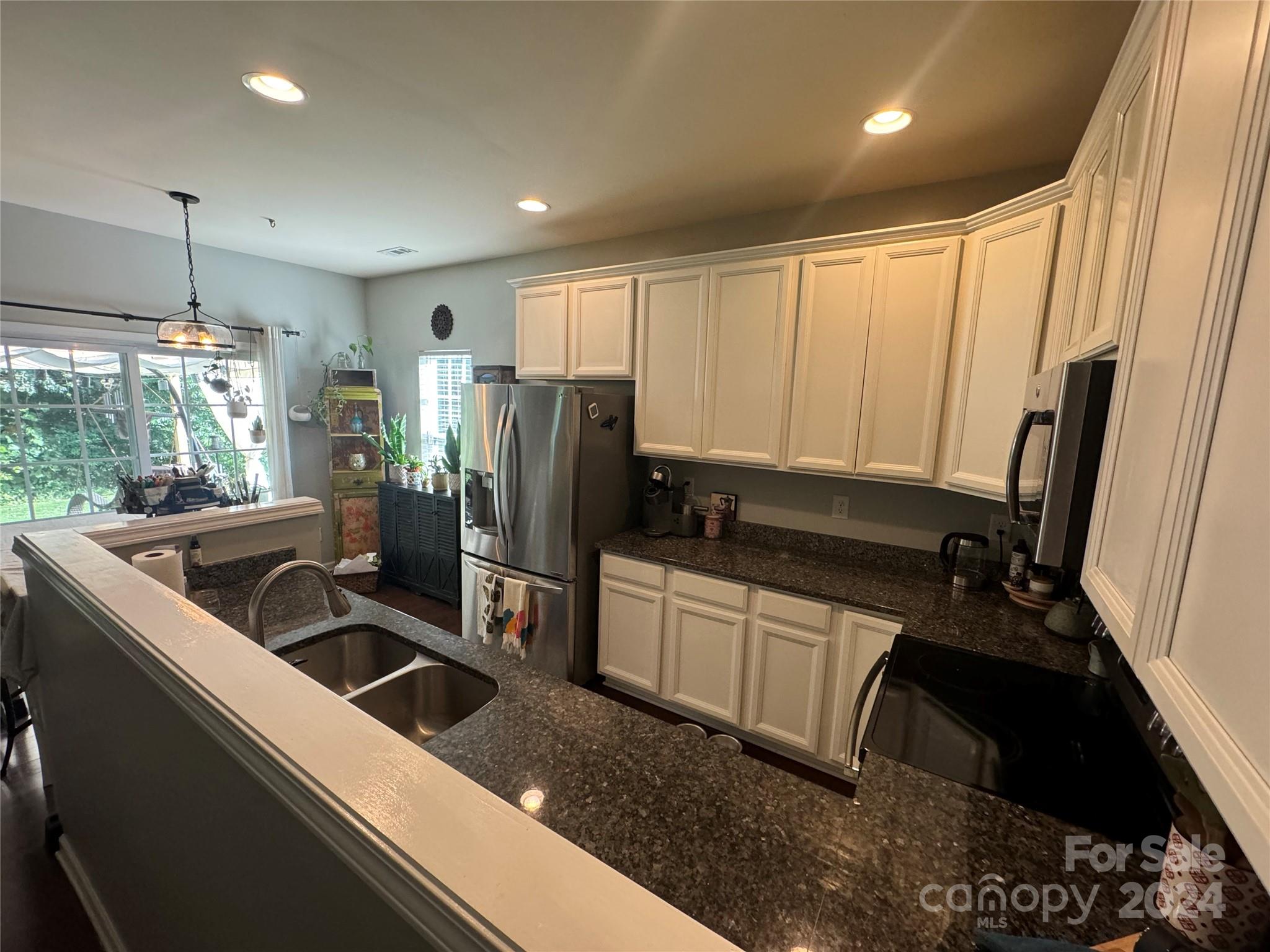 162 Limerick Road, Unit A Mooresville, NC 28115 - Photo 5 of 20 a kitchen with stainless steel appliances a sink a stove a refrigerator a window