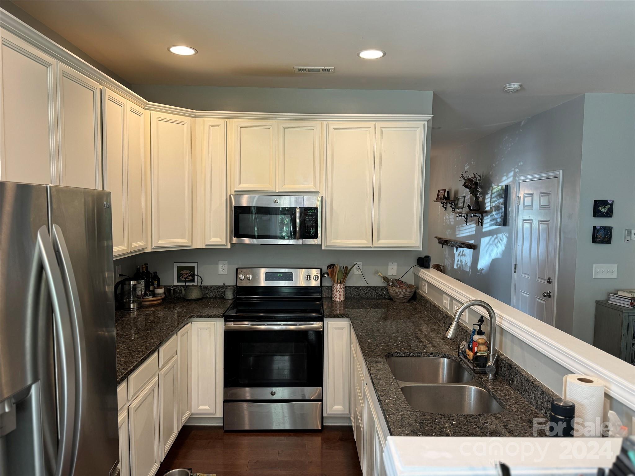 162 Limerick Road, Unit A Mooresville, NC 28115 - Photo 6 of 20 a kitchen with stainless steel appliances granite countertop a sink a stove and refrigerator