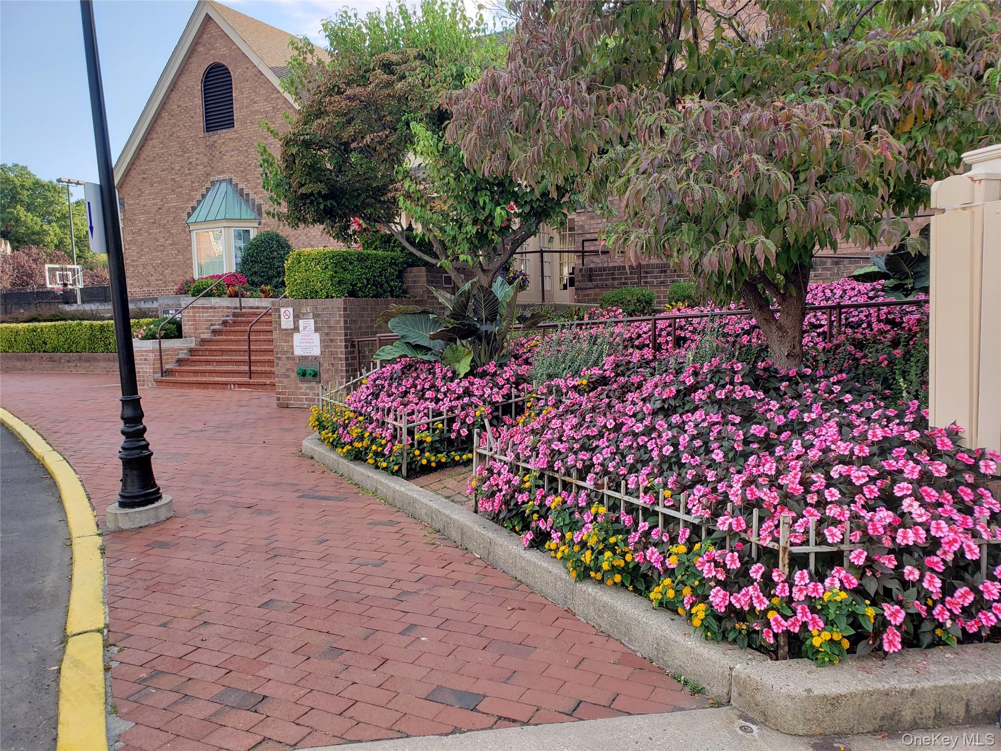 12-30 Estates Lane, Unit 2 Queens, NY 11360 - Photo 1 of 9 View of property's community featuring stairs