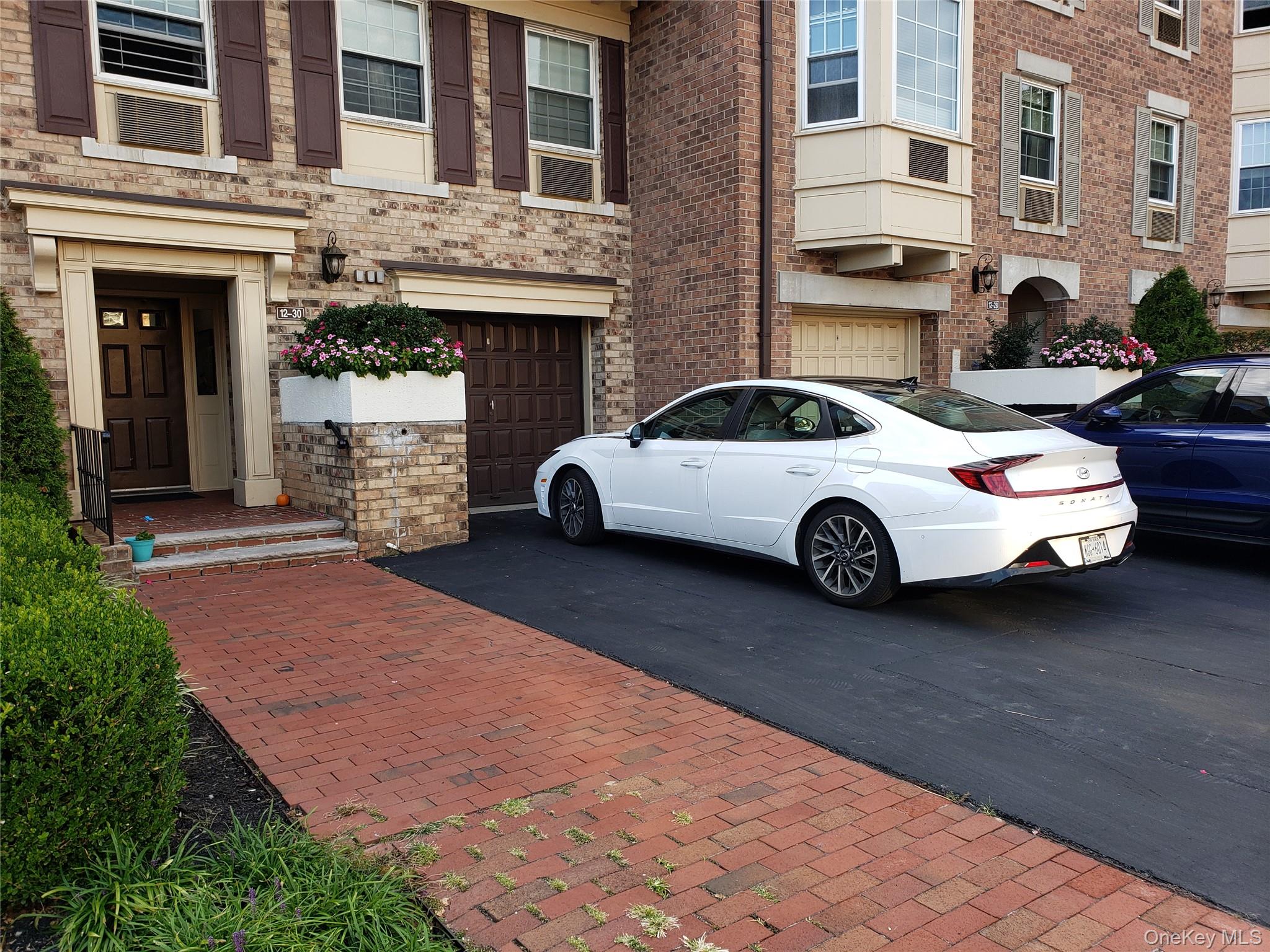 12-30 Estates Lane, Unit 2 Queens, NY 11360 - Photo 2 of 9 Doorway and Driveway with private Garage