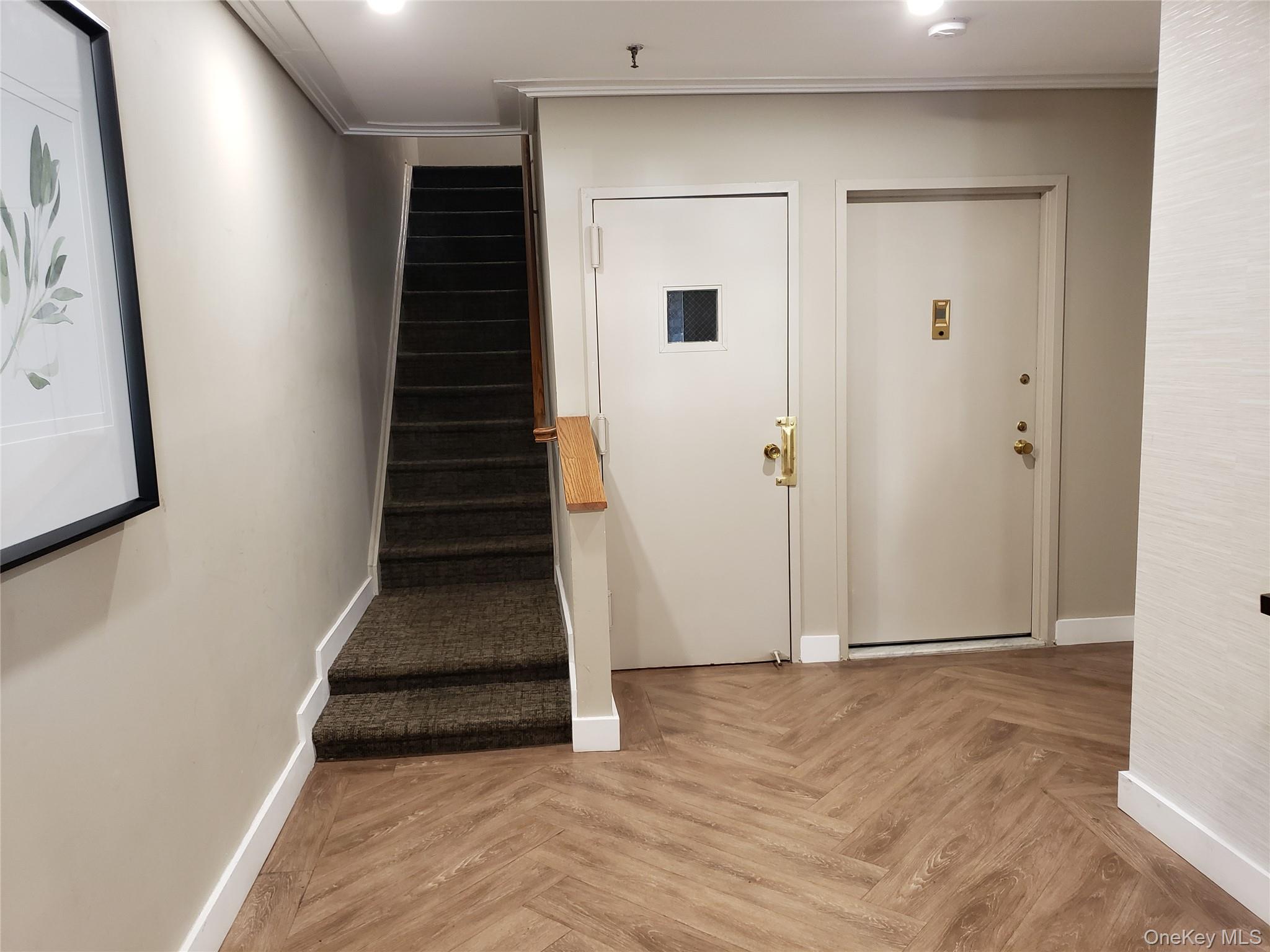 12-30 Estates Lane, Unit 2 Queens, NY 11360 - Photo 8 of 9 Staircase featuring crown molding