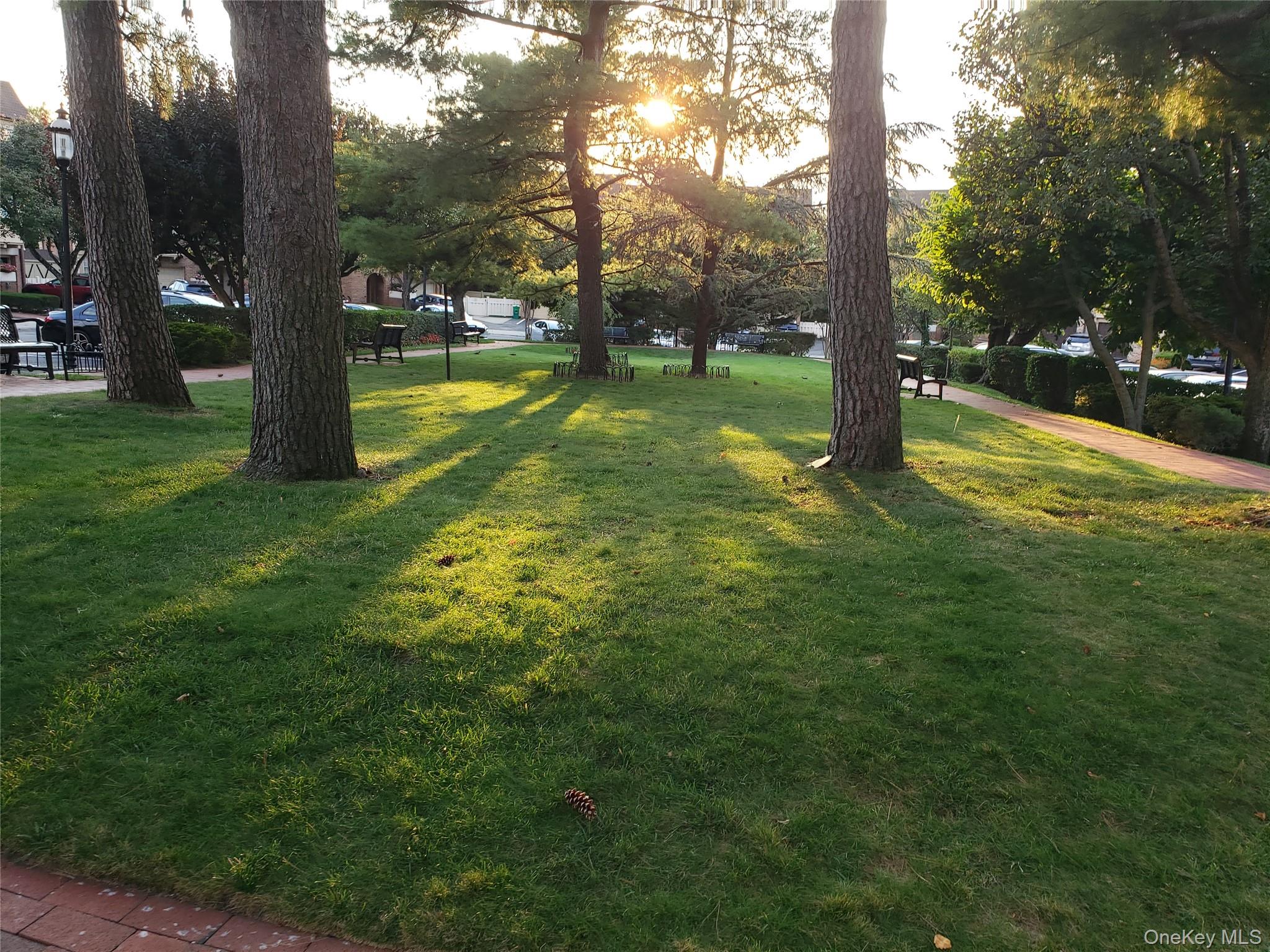 12-30 Estates Lane, Unit 2 Queens, NY 11360 - Photo 9 of 9 Surrounding community featuring a lawn