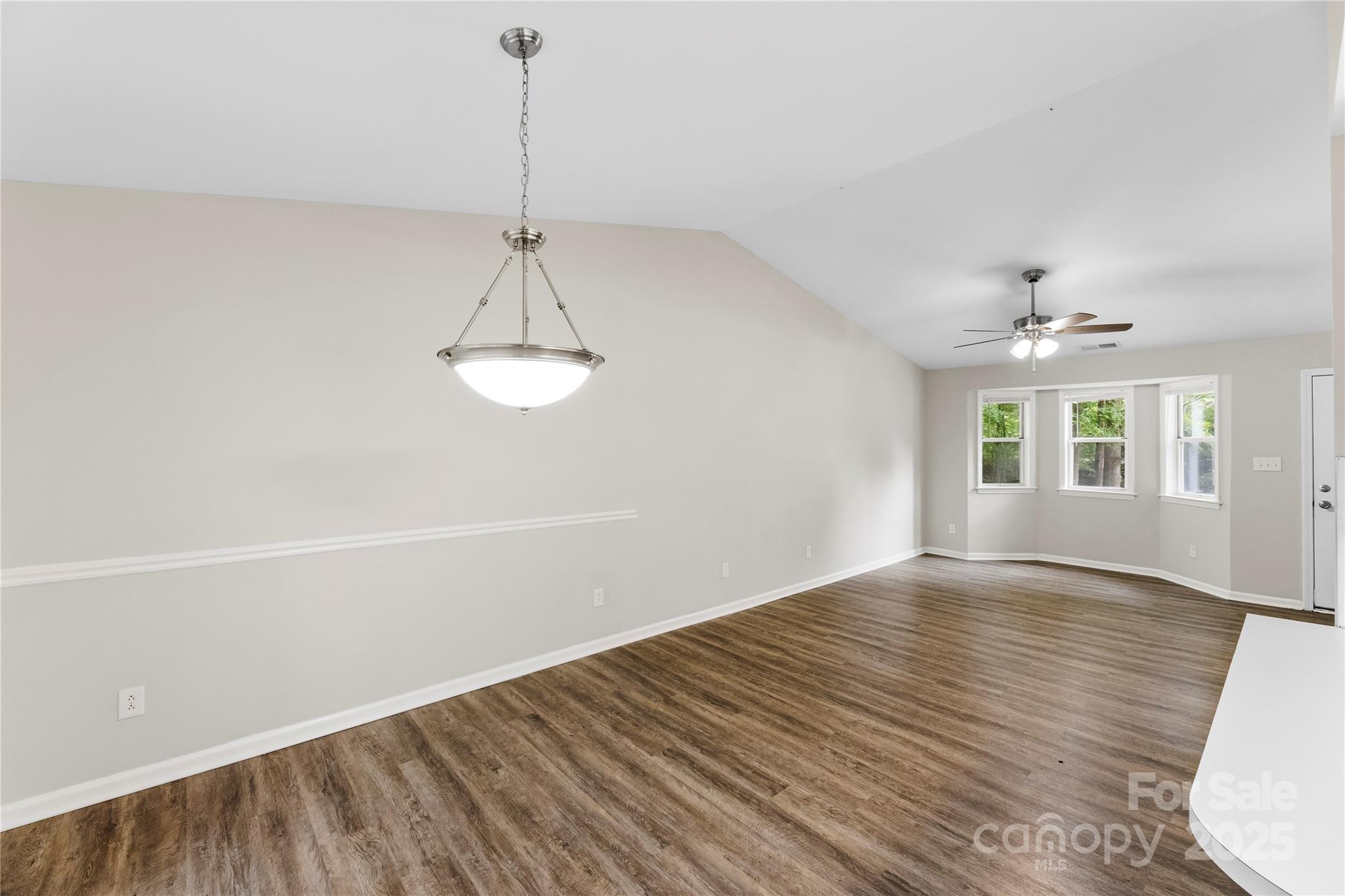 2713 Faircroft Way Monroe, NC 28110 - Photo 17 of 25 a view of an empty room with wooden floor and a window