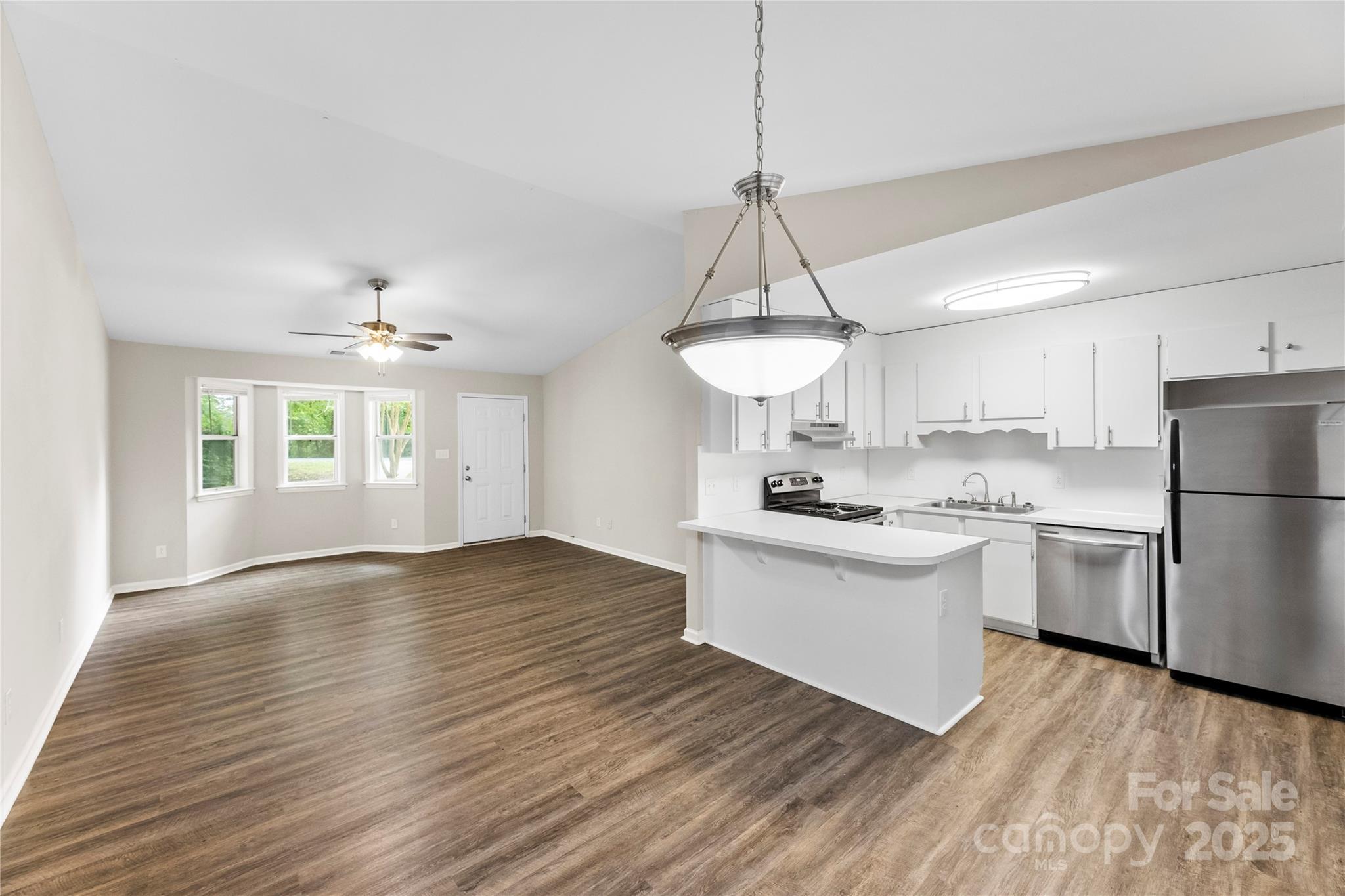 2713 Faircroft Way Monroe, NC 28110 - Photo 2 of 25 a kitchen with stainless steel appliances granite countertop a sink stove and refrigerator