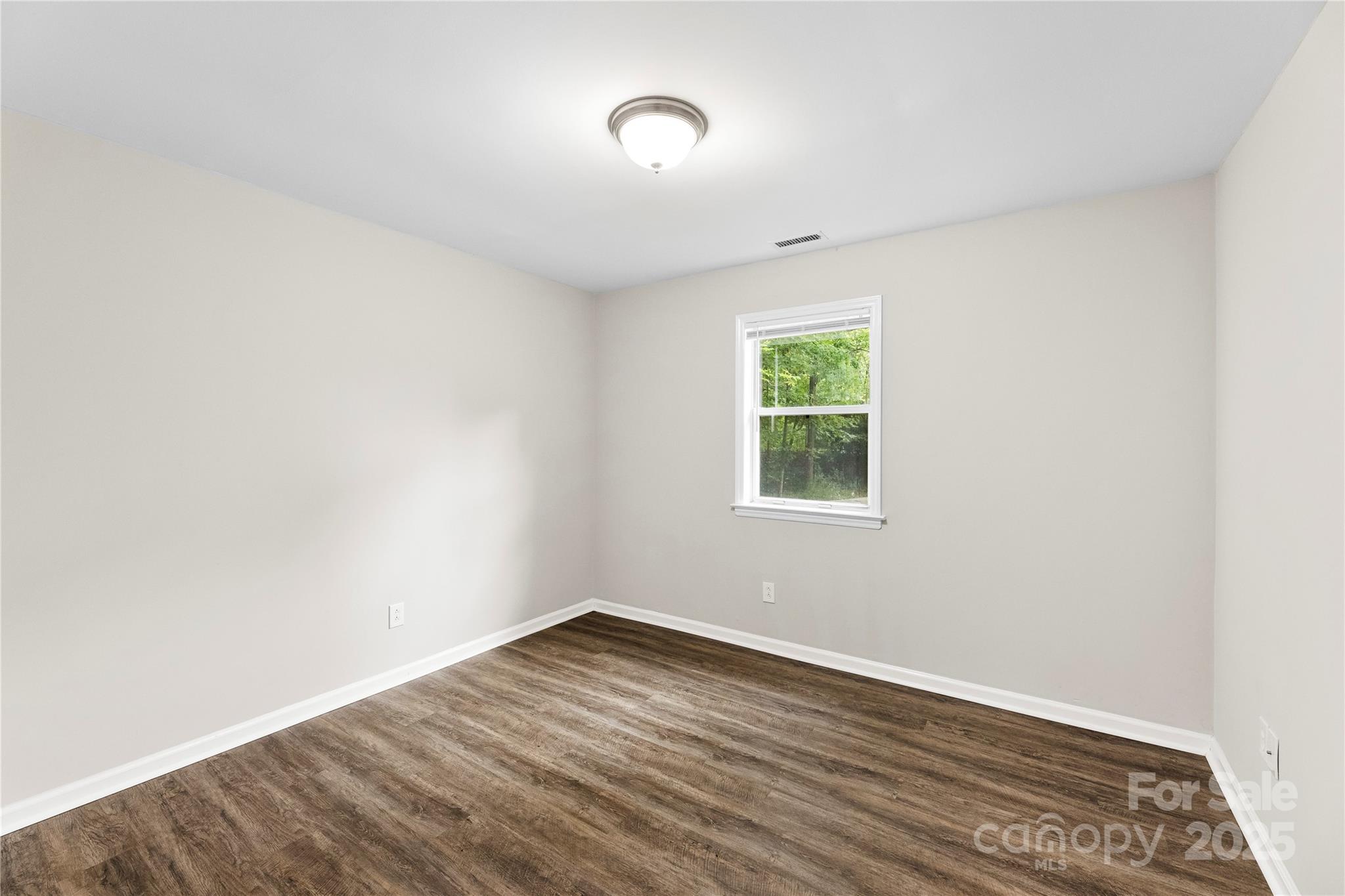 2713 Faircroft Way Monroe, NC 28110 - Photo 3 of 25 an empty room with wooden floor and windows