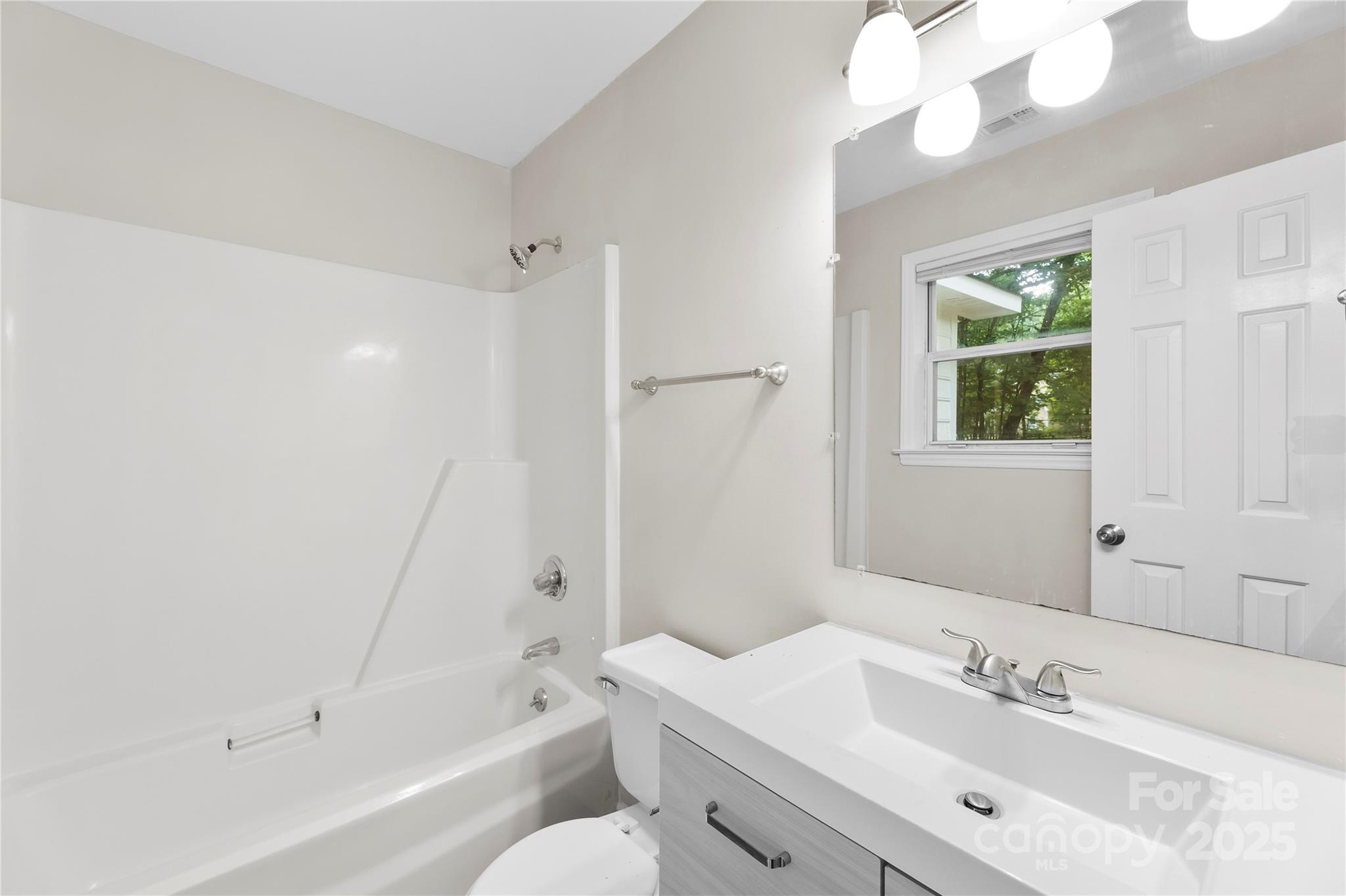 2713 Faircroft Way Monroe, NC 28110 - Photo 5 of 25 a bathroom with a bathtub a sink a toilet and a mirror