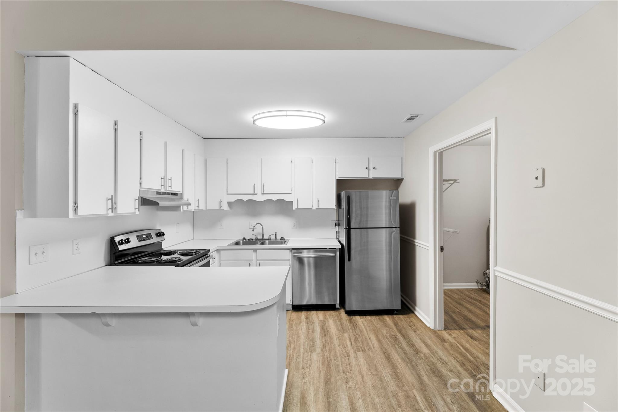 2713 Faircroft Way Monroe, NC 28110 - Photo 9 of 25 a kitchen with a sink a refrigerator a stove and cabinets