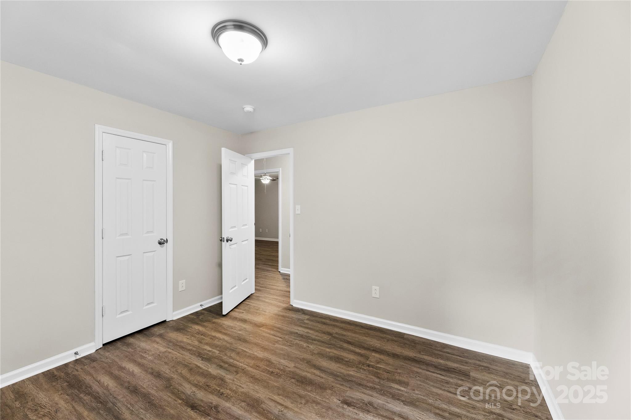 2713 Faircroft Way Monroe, NC 28110 - Photo 10 of 25 a view of an empty room with wooden floor and a window