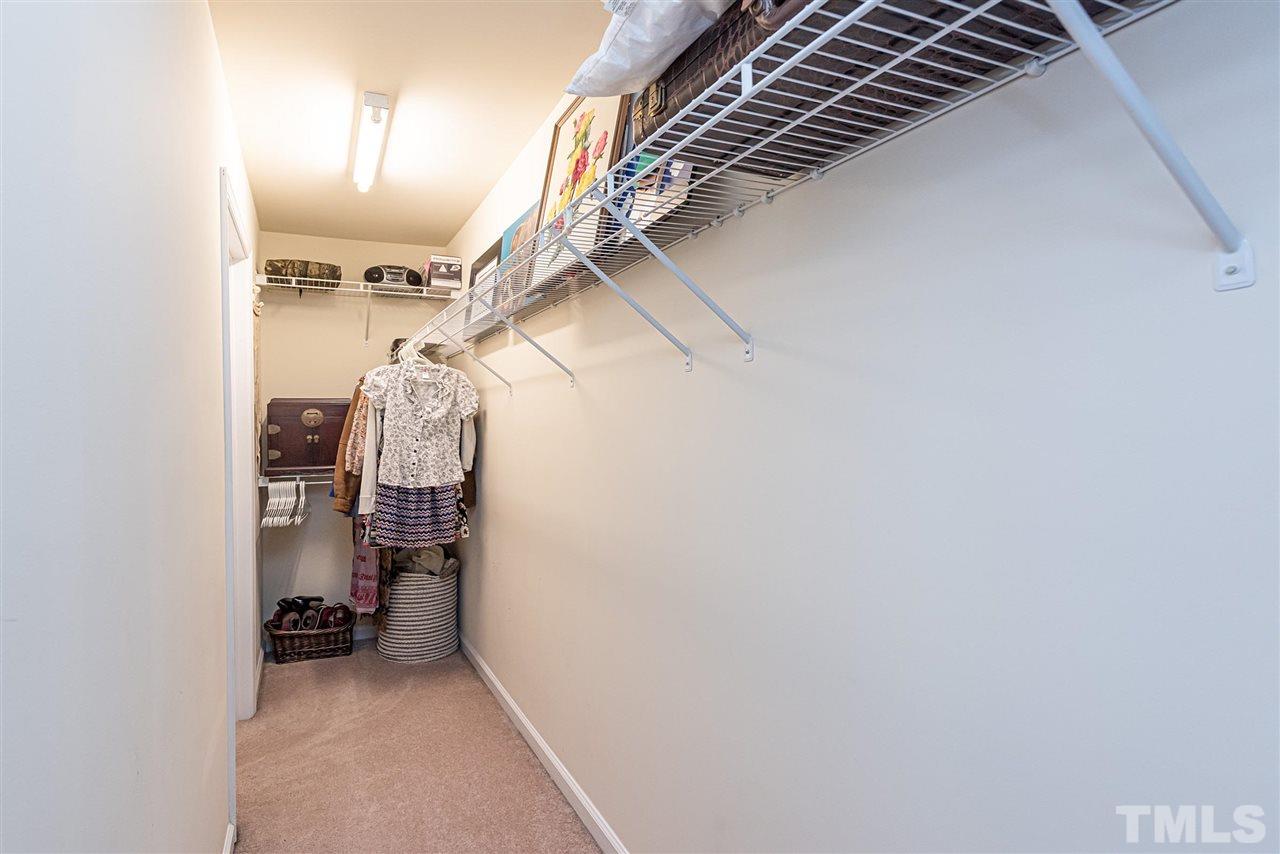 7749 Winners Edge Street Raleigh, NC 27617 - Photo 13 of 29 a view of walk in closet with clothes and shoes