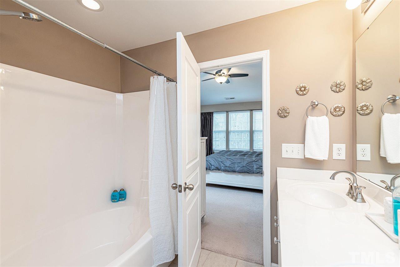 7749 Winners Edge Street Raleigh, NC 27617 - Photo 15 of 29 a en suite bathroom with a tub shower and sink