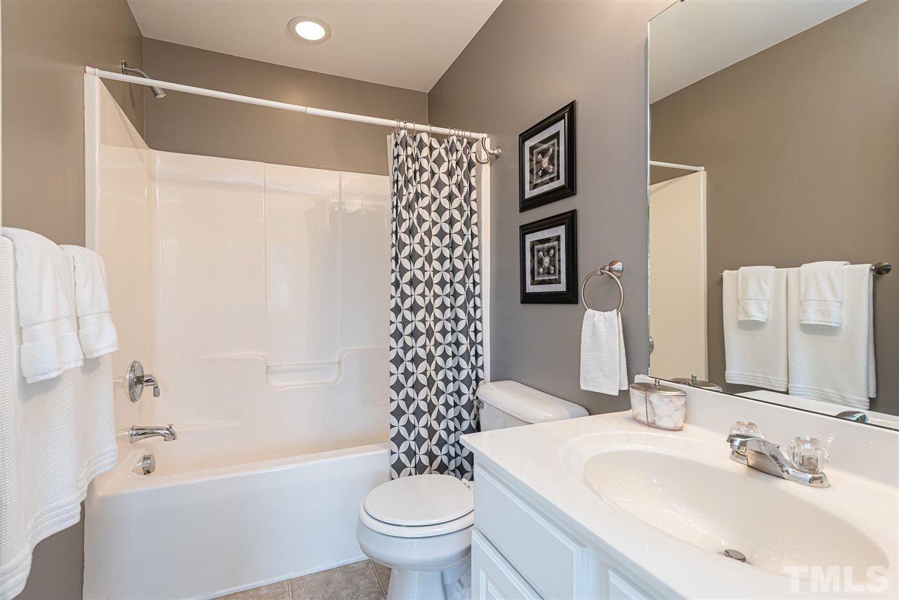 7749 Winners Edge Street Raleigh, NC 27617 - Photo 18 of 29 a bathroom with a sink toilet and shower