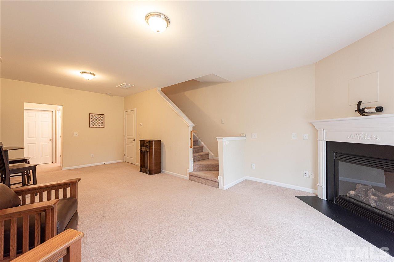7749 Winners Edge Street Raleigh, NC 27617 - Photo 20 of 29 a view of livingroom with furniture and fireplace