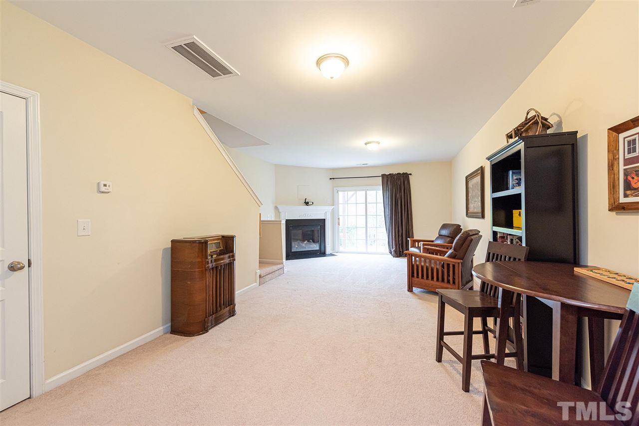 7749 Winners Edge Street Raleigh, NC 27617 - Photo 22 of 29 a view of livingroom with furniture and fireplace