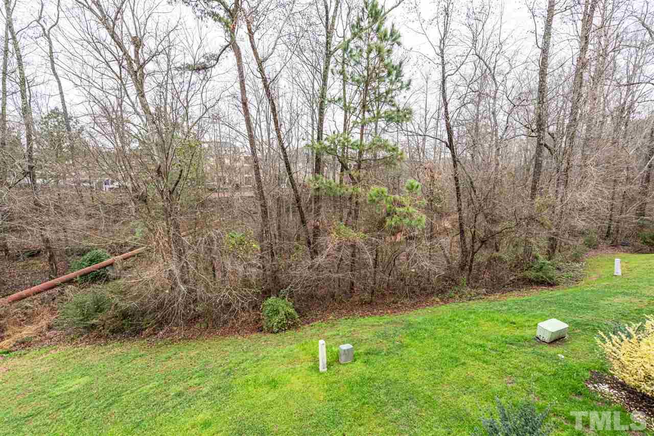 7749 Winners Edge Street Raleigh, NC 27617 - Photo 27 of 29 a view of a backyard with large trees