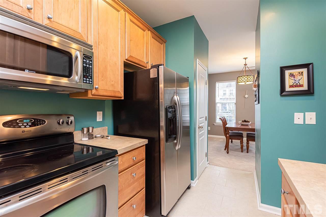 7749 Winners Edge Street Raleigh, NC 27617 - Photo 5 of 29 a kitchen with a stove and a microwave