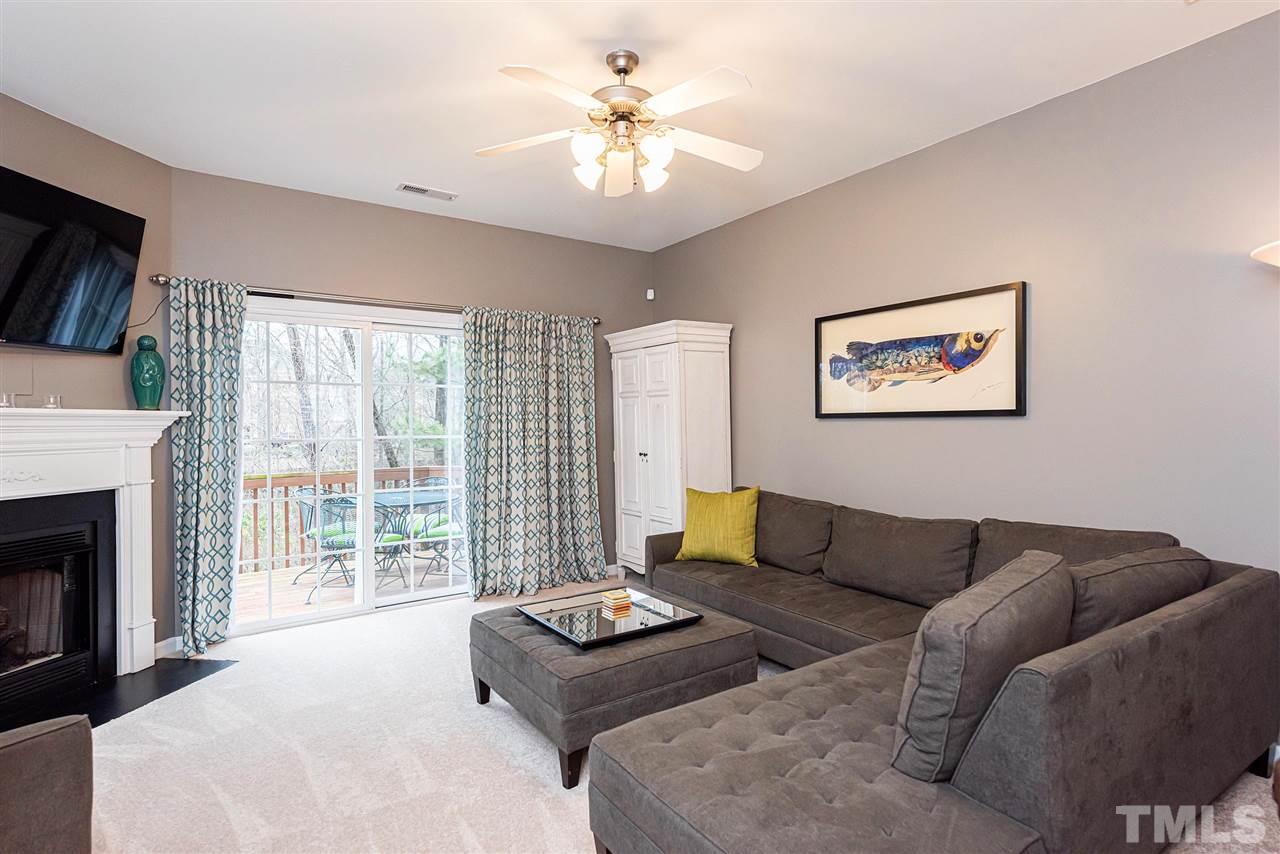 7749 Winners Edge Street Raleigh, NC 27617 - Photo 6 of 29 a living room with furniture and a fireplace
