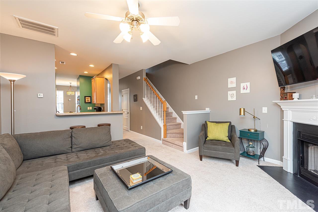 7749 Winners Edge Street Raleigh, NC 27617 - Photo 8 of 29 a living room with furniture and a flat screen tv