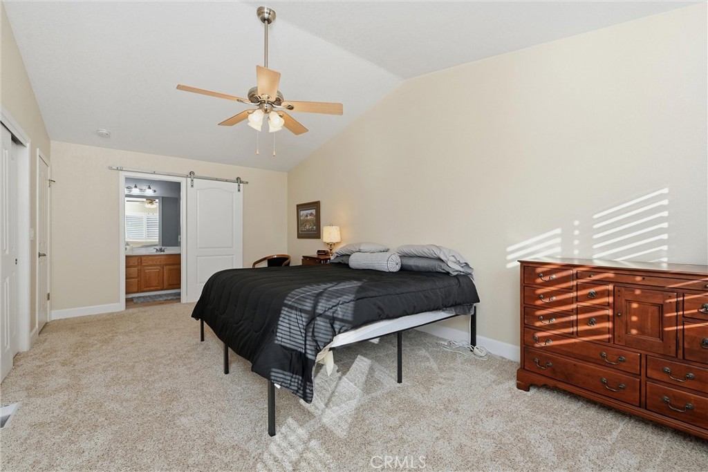 19093 Ravenhill Road Hidden Valley Lake, CA 95467 - Photo 19 of 30 a bedroom with a bed and a chandelier