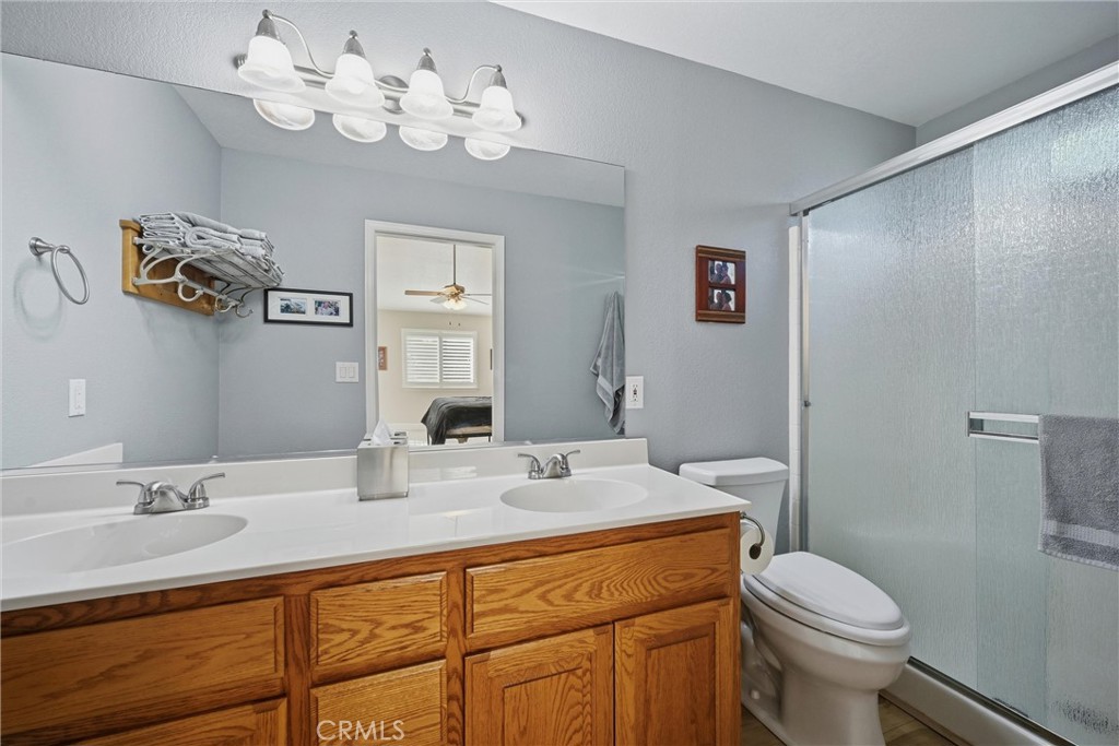19093 Ravenhill Road Hidden Valley Lake, CA 95467 - Photo 20 of 30 a bathroom with a sink a toilet and a mirror