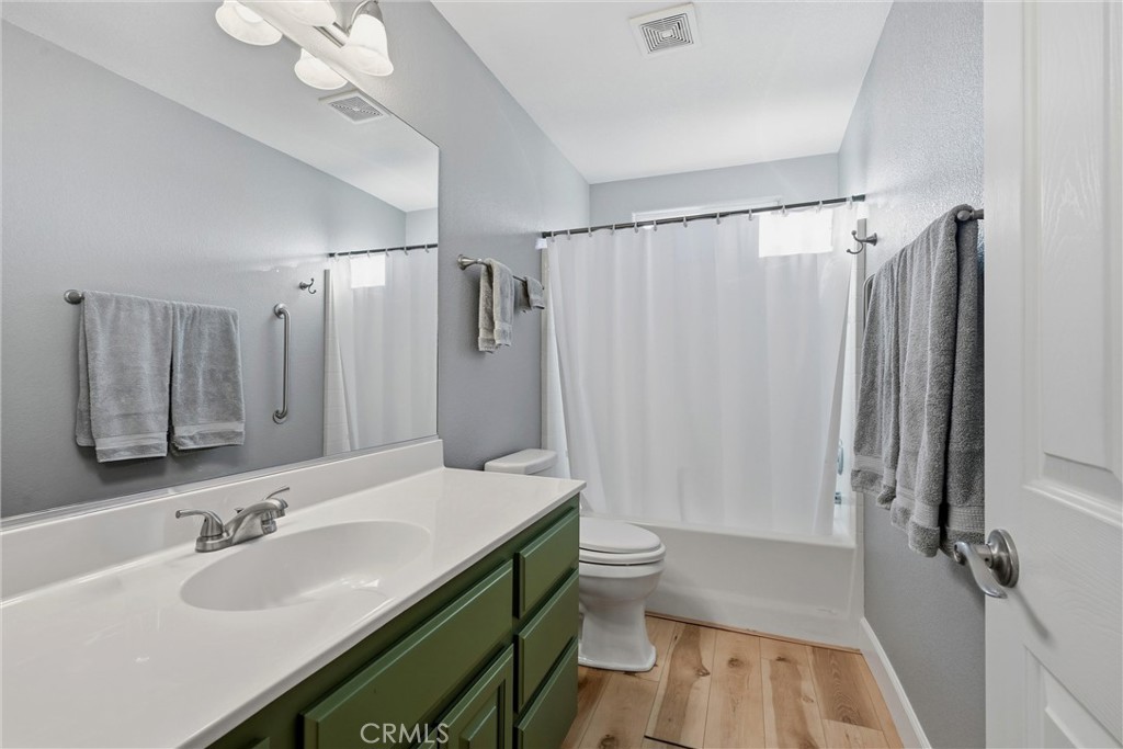 19093 Ravenhill Road Hidden Valley Lake, CA 95467 - Photo 23 of 30 a bathroom with a sink a toilet a mirror and shower