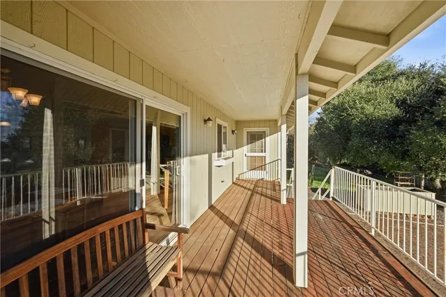 a view of balcony with wooden floor and outdoor seating