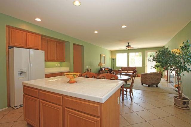 a view of kitchen island a sink a table and chairs