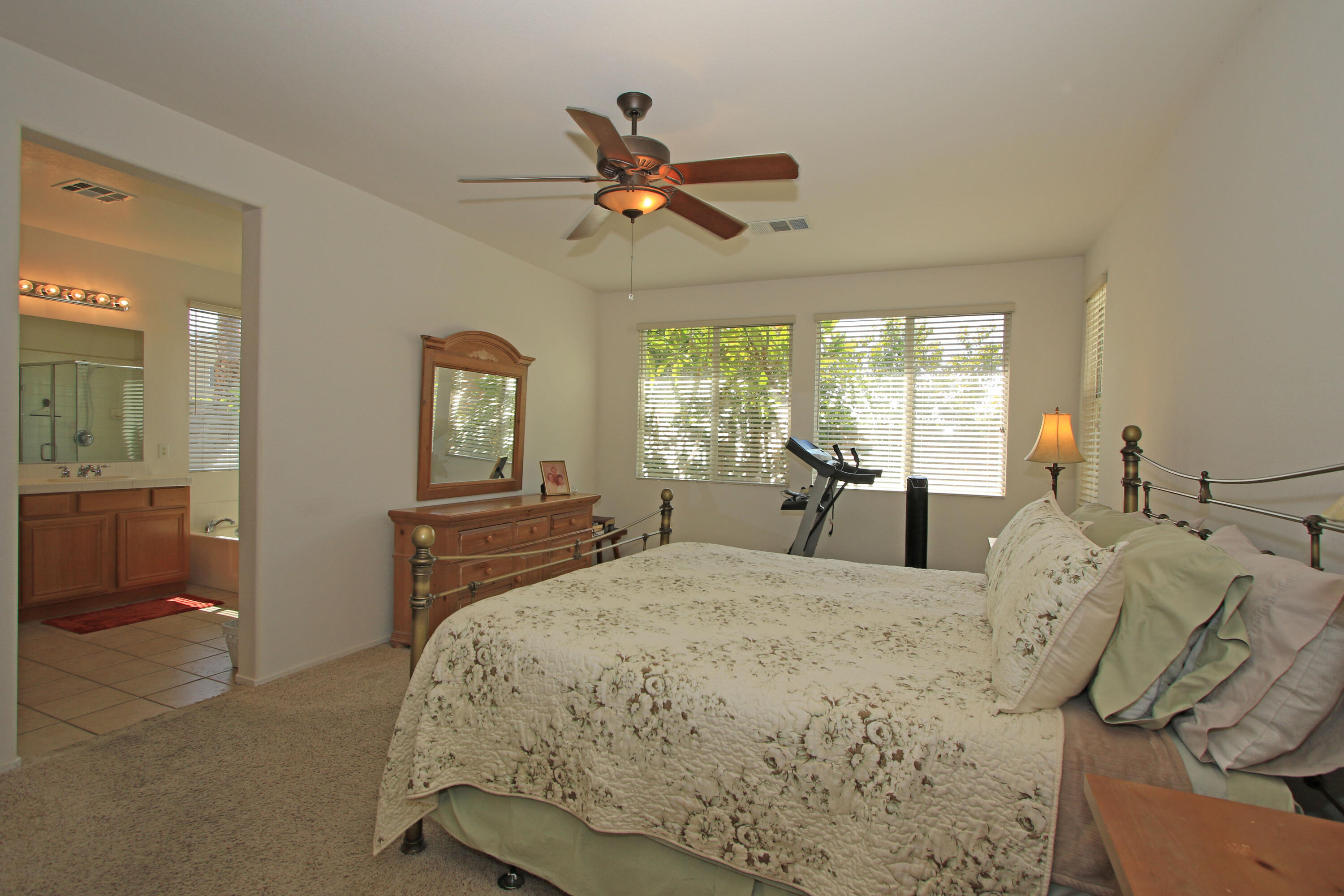 37330 Haweswater Road Indio, CA 92203 - Photo 20 of 47 a bedroom with a bed and a chandelier