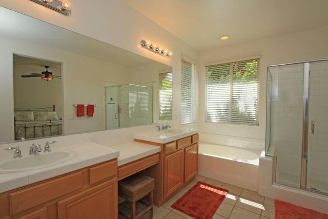 a bathroom with a tub sink and mirror