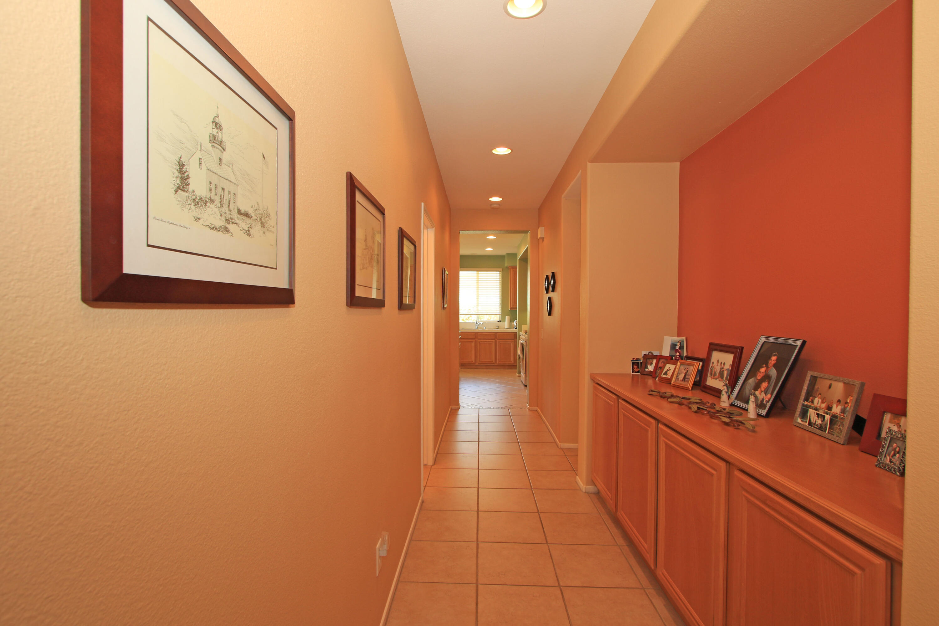 37330 Haweswater Road Indio, CA 92203 - Photo 32 of 47 a hallway with a couch and wooden floor