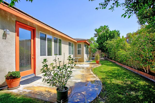 a view of a garden with a house