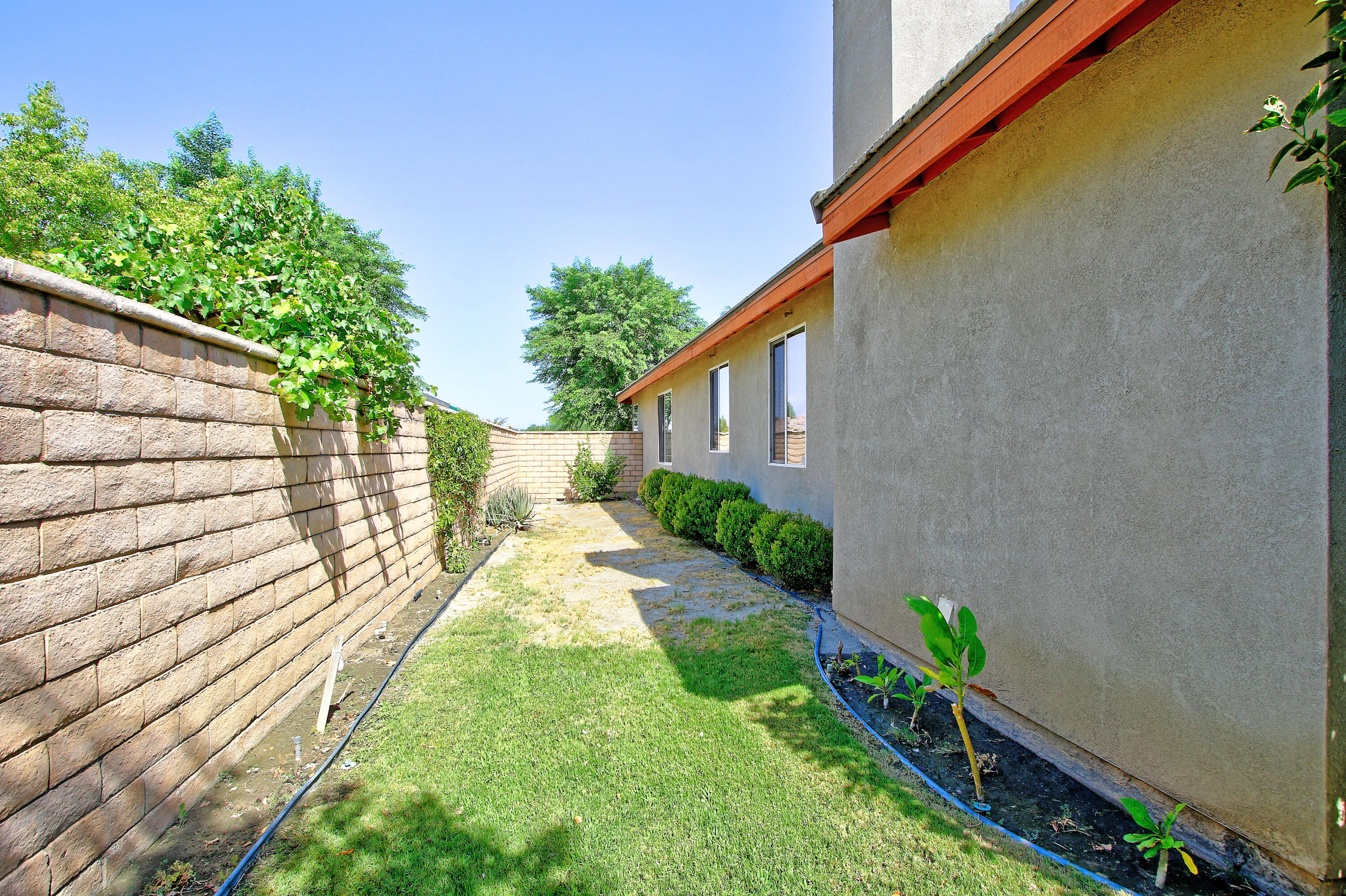 37330 Haweswater Road Indio, CA 92203 - Photo 40 of 47 a view of a house with a yard and wooden fence