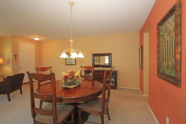 a view of a dining room with furniture and chandelier