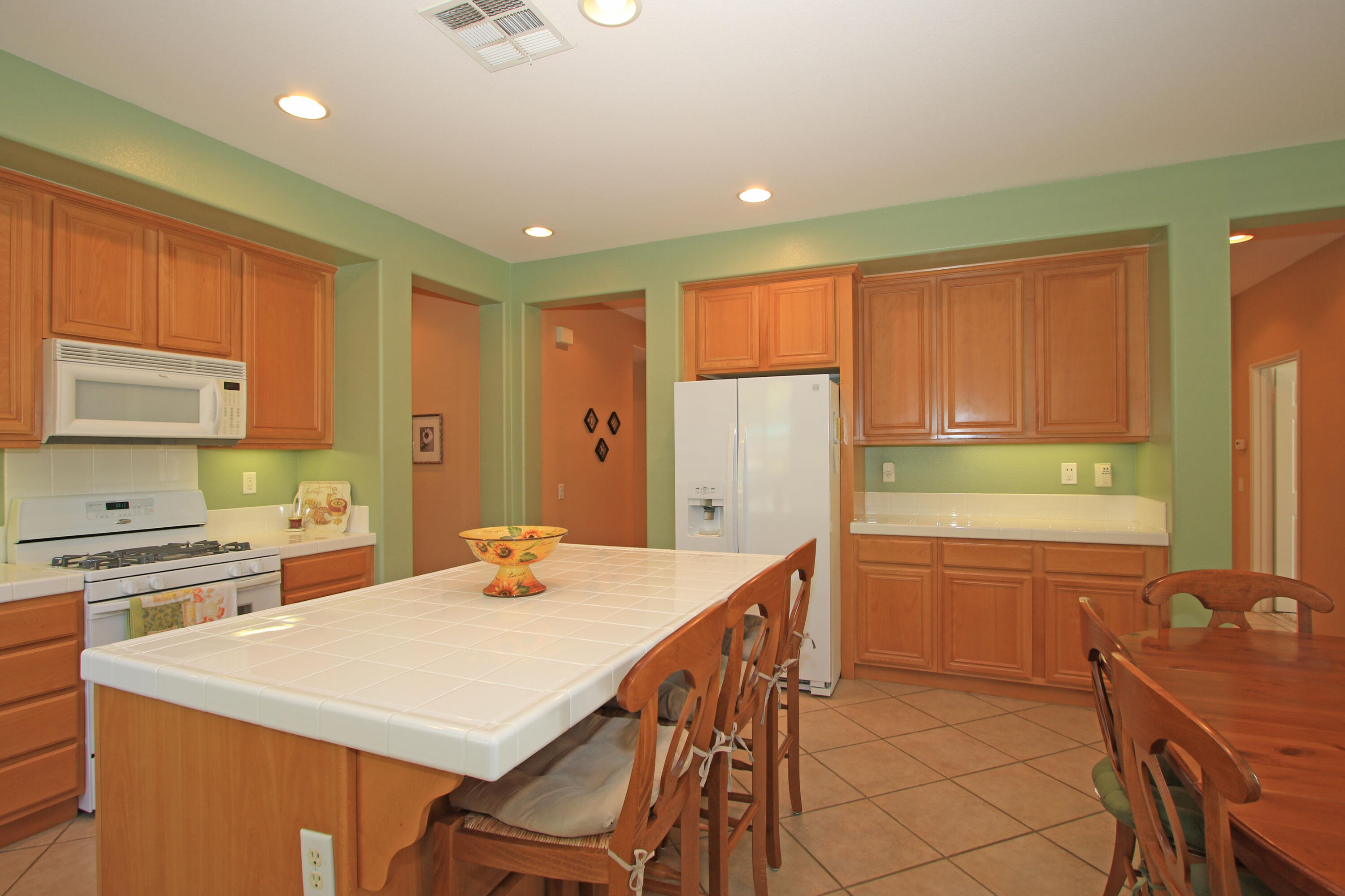 37330 Haweswater Road Indio, CA 92203 - Photo 10 of 47 a kitchen with a stove a sink a refrigerator and a dining table