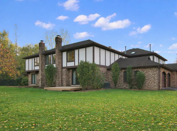 a front view of a house with a garden and yard