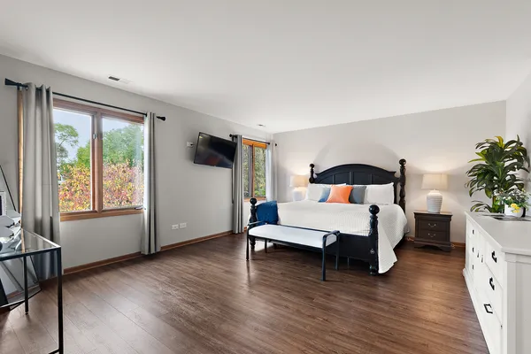 a bedroom with a bed and a night stand