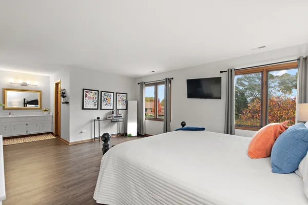 a bedroom with a large bed and a workspace