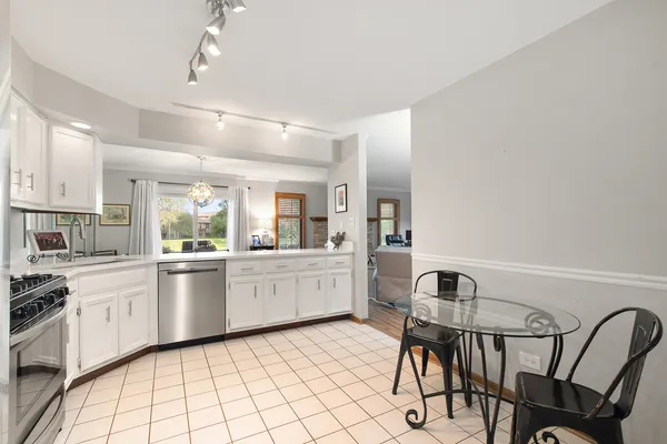 a bathroom with a granite countertop toilet sink and mirror