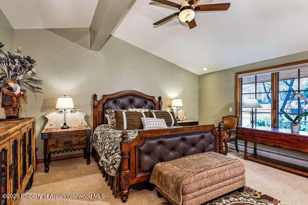 a bedroom with a bed window and a dresser