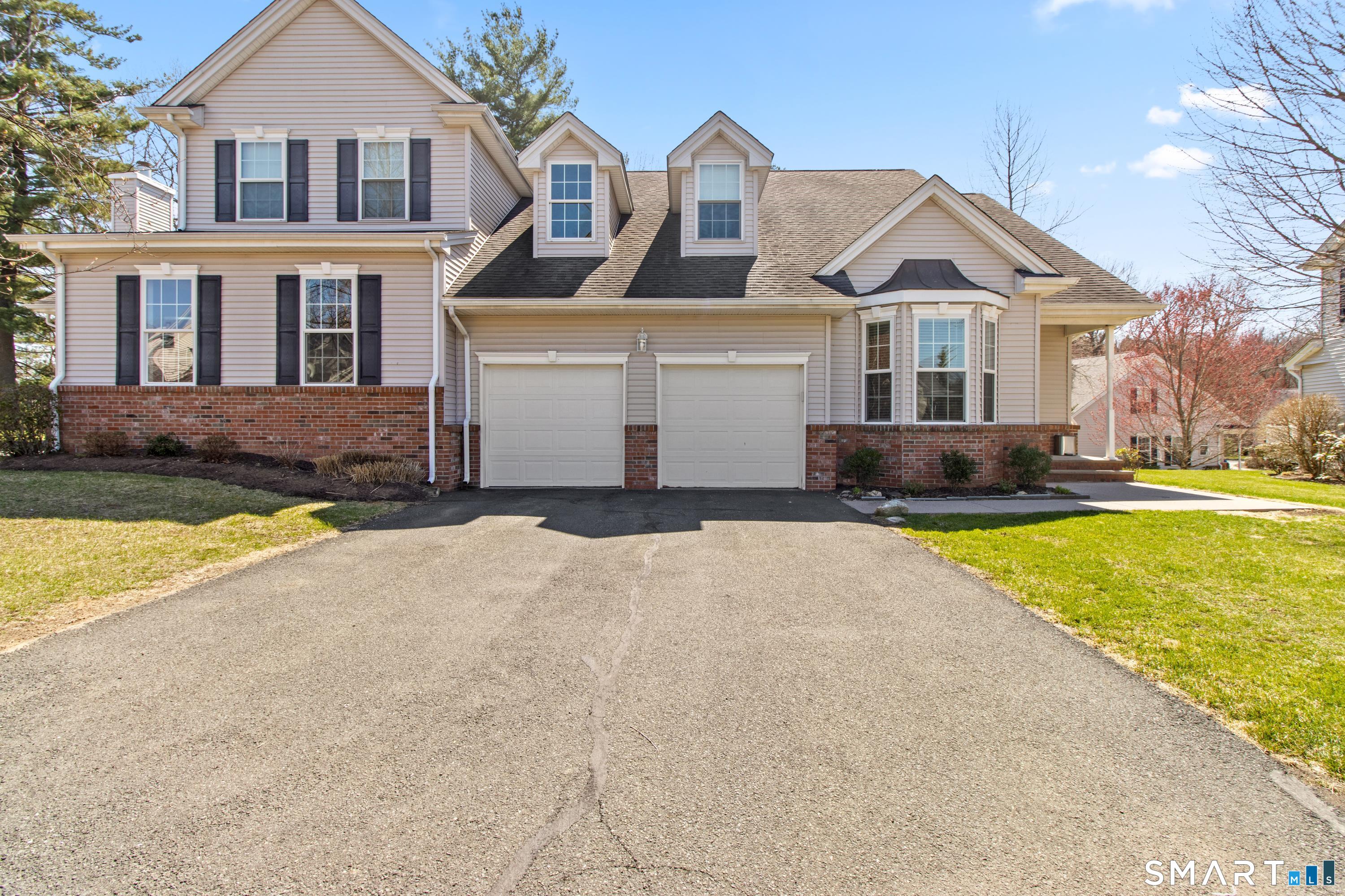 5 Haskins Road, Unit 5 Windsor, CT 06095 - Photo 12 of 40 a front view of a house with a yard and trees