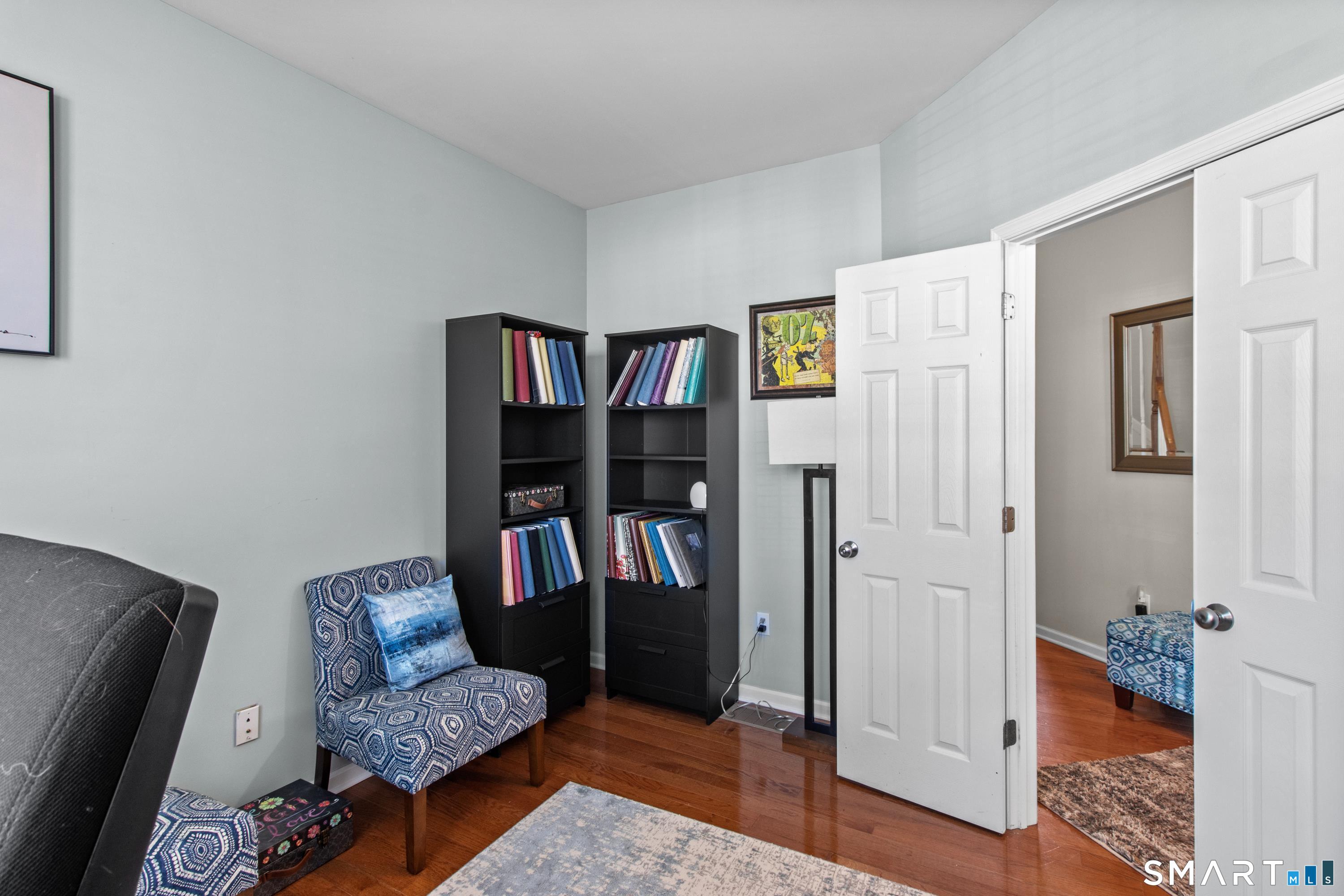 5 Haskins Road, Unit 5 Windsor, CT 06095 - Photo 17 of 40 a living room with furniture and a book shelf