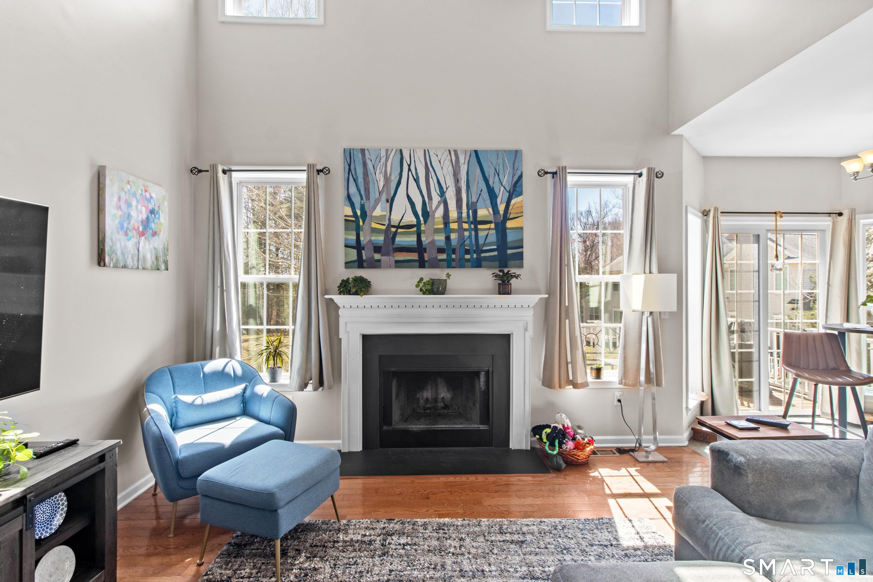 5 Haskins Road, Unit 5 Windsor, CT 06095 - Photo 21 of 40 a living room with furniture a rug a fireplace and a large window