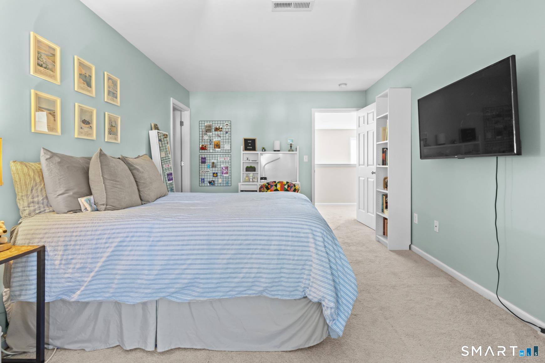 5 Haskins Road, Unit 5 Windsor, CT 06095 - Photo 31 of 40 a spacious bedroom with a bed and a flat screen tv