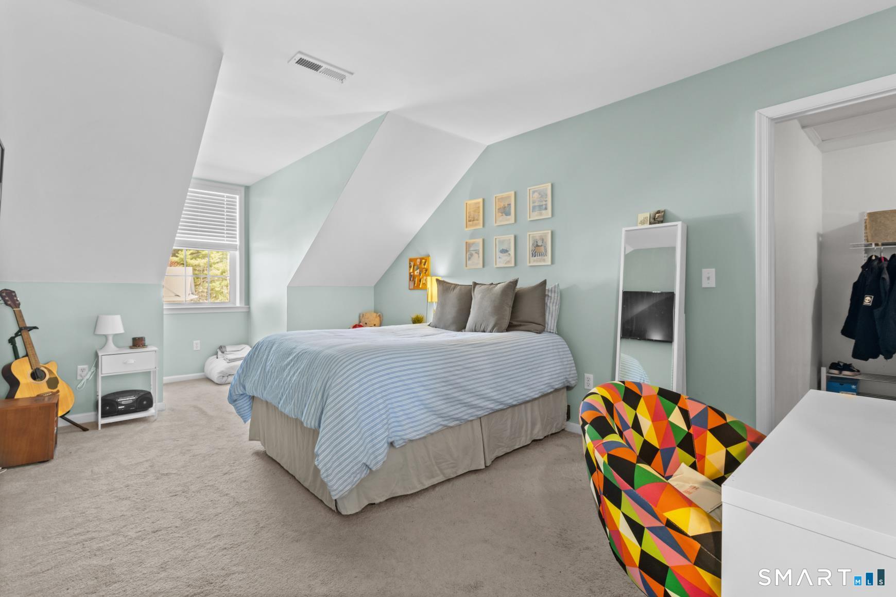 5 Haskins Road, Unit 5 Windsor, CT 06095 - Photo 32 of 40 a spacious bedroom with a bed and a lamp on the dresser in it