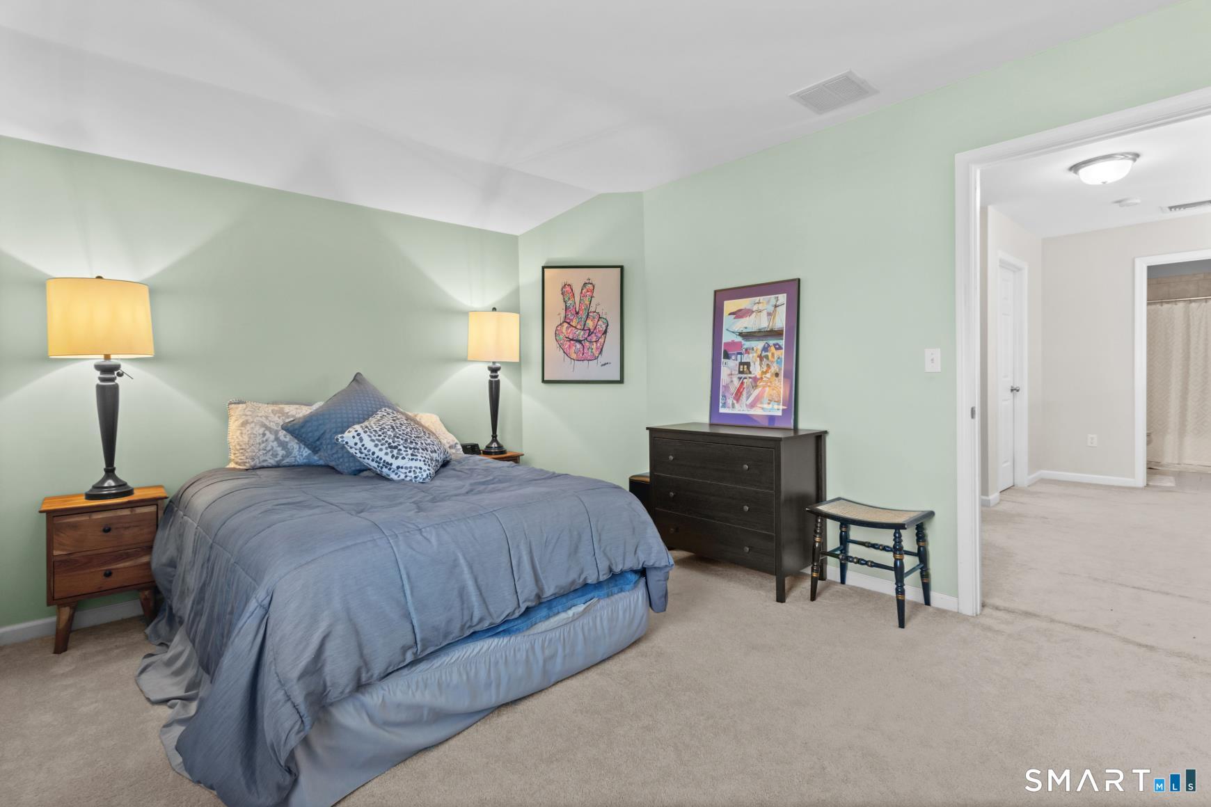 5 Haskins Road, Unit 5 Windsor, CT 06095 - Photo 33 of 40 a bedroom with a bed and a lamp on table